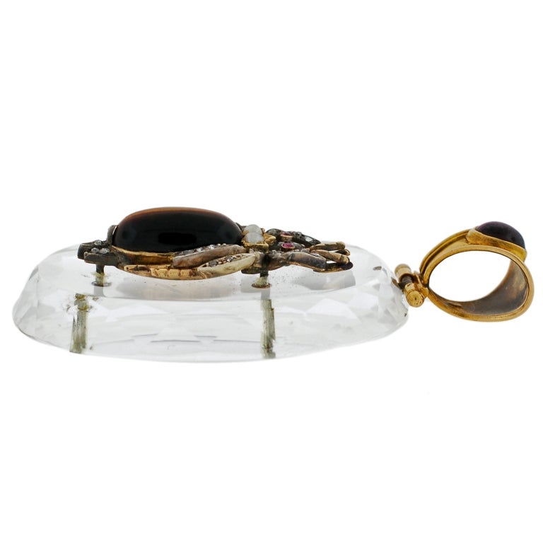 An absolutely fabulous rock quartz crystal pendant from the Victorian (ca1880) era! This lovely piece is comprised of a single plaque of rock quartz crystal, which is particularly large in size. The crystal is oval shaped with a faceted edge that