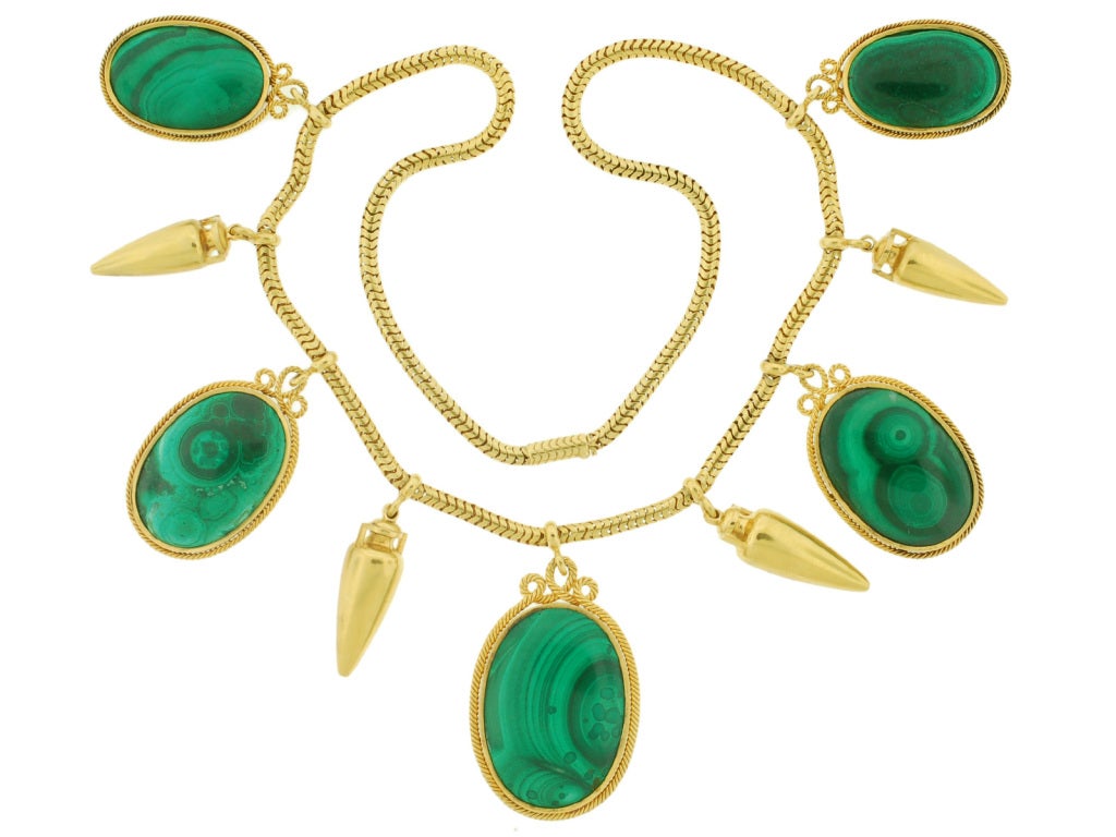 An absolutely stunning and important malachite necklace from the Victorian era! The necklace is comprised of 9 alternating links which hang from a 15kt yellow gold chain. The chain is a handmade snake chain that rests beautifully on the neck. Large