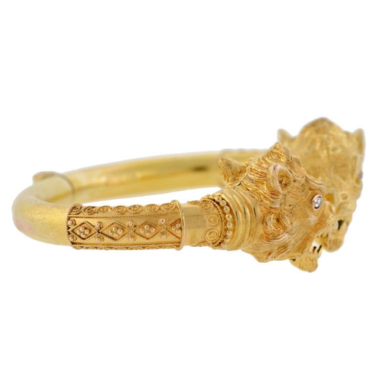 An absolutely striking and unusual gold bracelet from Victorian (ca1880! This hand wrought piece is made of vibrant 14kt gold and stemming from each end is a 3-dimensional, wolf-like head. Each animal is beautifully detailed with textured fur,