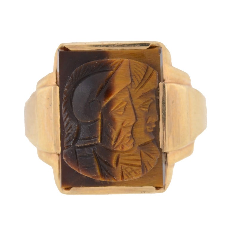 A fantastic carved tiger's eye cameo locket ring from the Victorian (ca1880) era! This unique ring is made of 10kt gold and features a rectangular shaped carved tiger's eye stone in the center of the ring. The hand carved cameo depicts the profiles