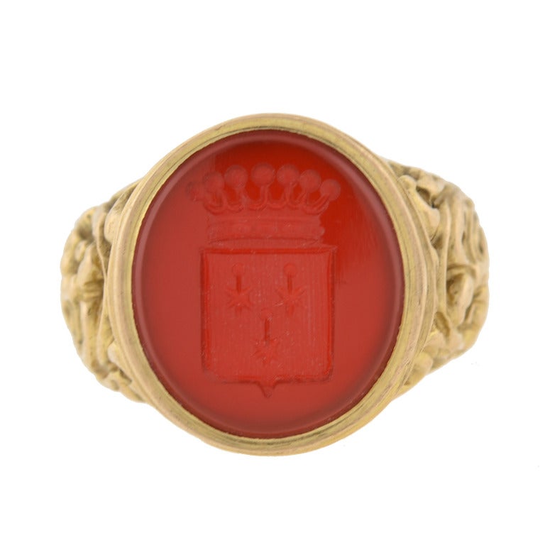 The opposite of a cameo, an intaglio is created by carving below the surface to produce and image in relief with the purpose of pressing into sealing wax, often used in signet rings. 
An incredibly beautiful intaglio signet ring from the Mid