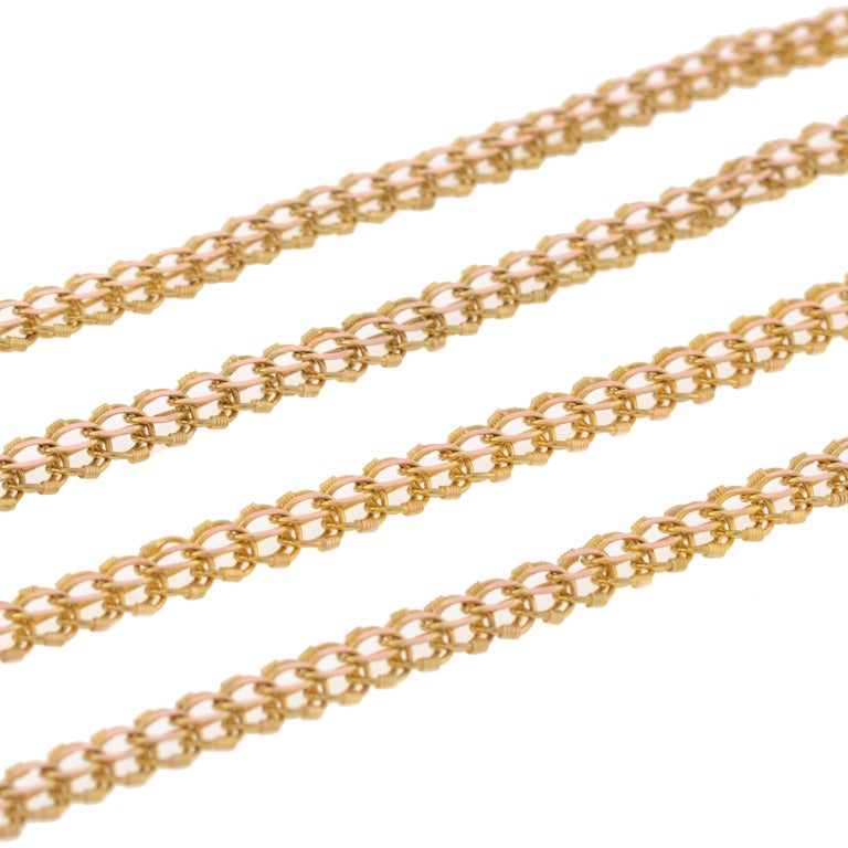 A fabulous chain from the Late Victorian (ca1890) era. Extremely long in length, the chain is made from 14kt yellow gold links which have a simple, beautiful design. Ornate, open wirework links connect together to form a 60