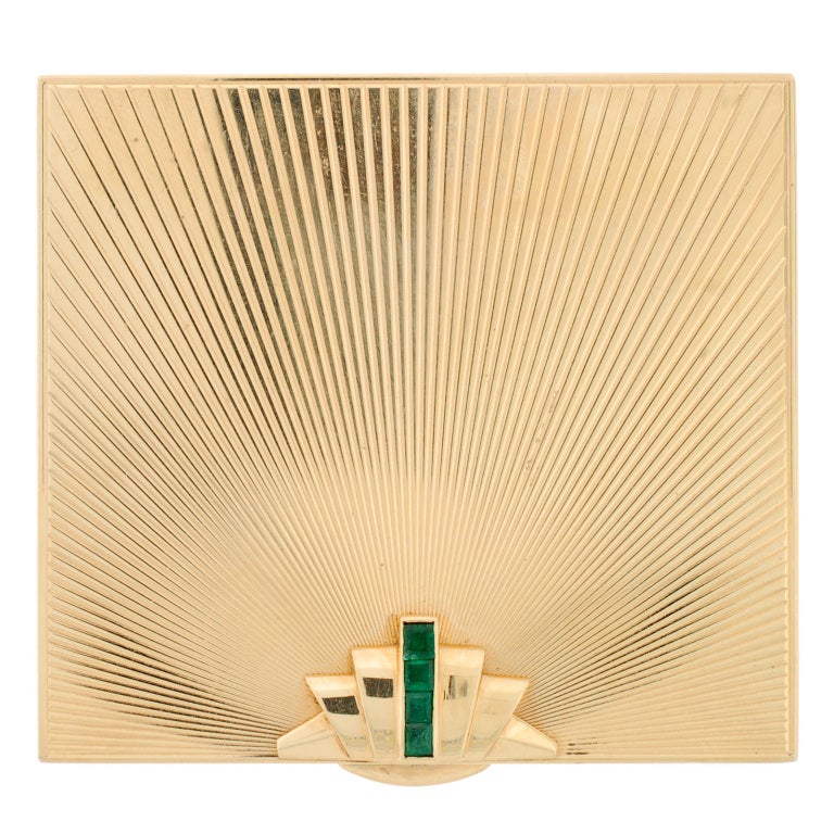 A stunning Retro compact from Tiffany & Co! The compact is made from 14kt solid yellow gold. The face of this compact has a simple design that holds four vibrant, square-cut emeralds. The exterior has a carved texture which perfectly represents