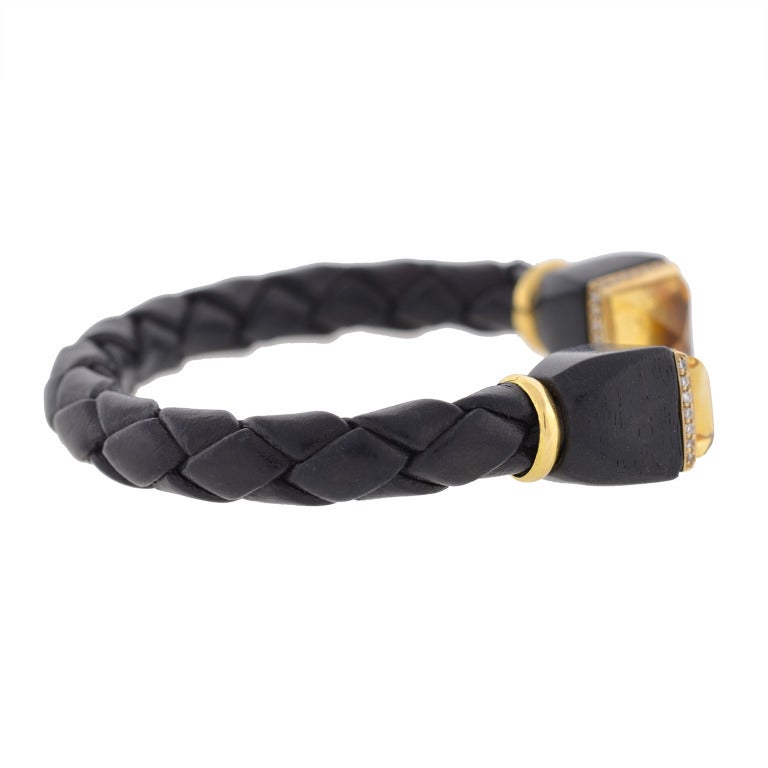 A fabulous signed Estate bracelet by French maker L'Oree Du Bois! This fashionable bracelet combines several materials to create a unique and very attractive look. The band of the bracelet is made of woven black leather which has been molded into a