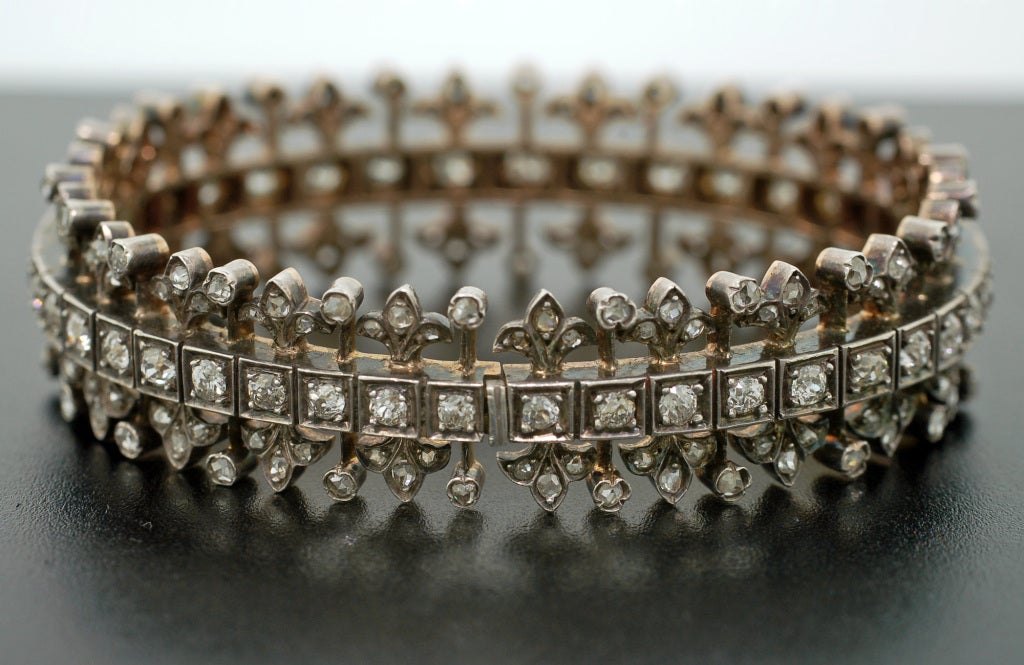 An absolutely magnificent French diamond bracelet from the Victorian era! This fabulous piece is made of 18kt gold which is topped in sterling silver and detailed with 10+ carats of sparkling old Rose and Mine Cut diamonds. With 3 hinged links, the