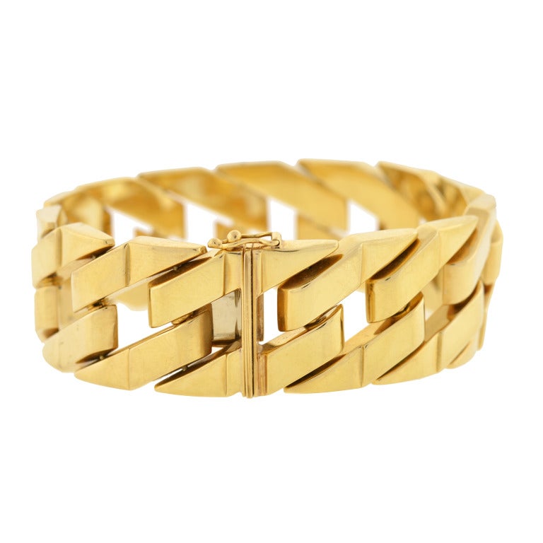 A fantastic Estate Cuban link bracelet! This fashionable piece is made of 18kt yellow gold and is comprised of 14 open diagonal shaped links which come together forming a classic, Cuban link bracelet. The bracelet, which is particularly wide has a