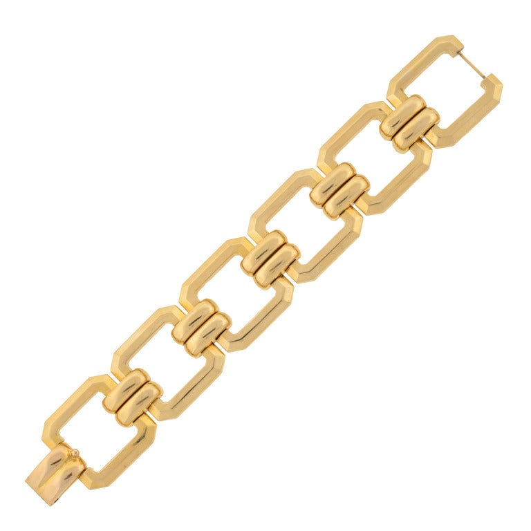 A fantastic gold link bracelet from the late Retro (ca1950) era! This fashionable piece is made of 14kt yellow gold and is comprised of 6 open square shaped links which have clipped corners. Each link connects together by a double bar design that