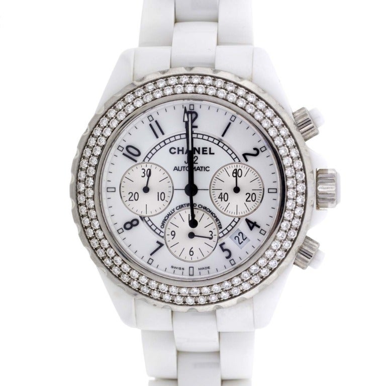 A fabulous contemporary Chanel wristwatch. This gorgeous watch is made of white ceramic and the front has a double row of diamonds. This J12 edition watch has three small dials which for minutes, seconds, as well as the date. The watch band is crisp