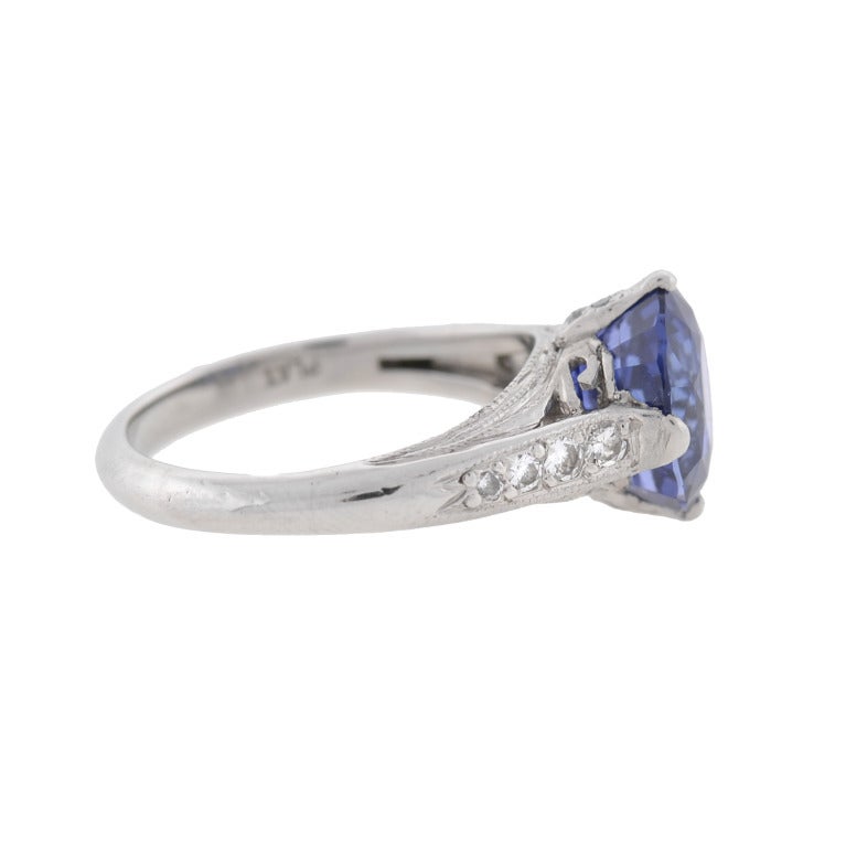 A wonderful Art Deco style sapphire and diamond ring! Made of platinum, this fantastic piece has an oval shaped Ceylon sapphire center with diamond accents resting on the shoulders. The vibrant center stone weighs 3.83ctw and has a wonderful, rich