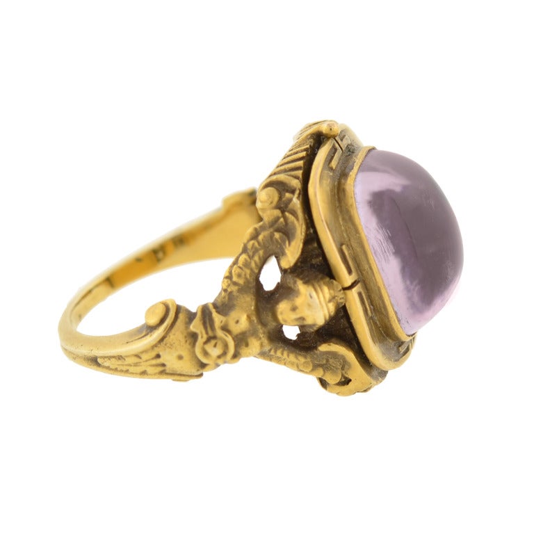 An absolutely fabulous and unusual amethyst ring from the Art Nouveau (ca1900) era! Simply stunning, this unusual ring is made of 14kt yellow gold and has a cabochon amethyst set in the center. The stone, which is bezel set, is foil backed and has