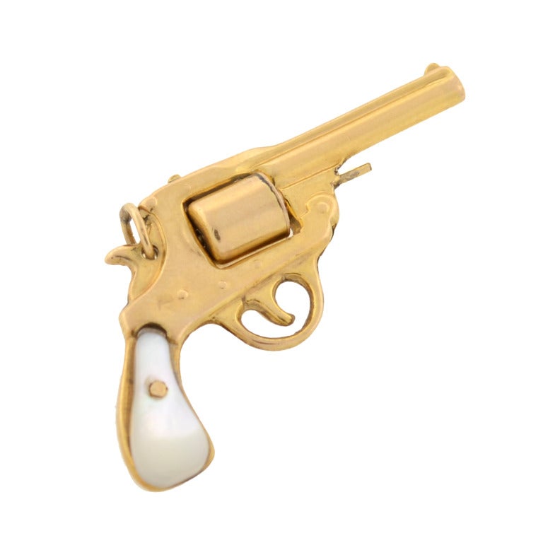An unusual gun pendant from the late Art Deco (c1930)era! This funky piece is made of 14kt yellow gold and portrays the shape of a pistol handgun. The gold gun has a realistic, 3-dimensional appearance complete with a barrel, slight, trigger, moving