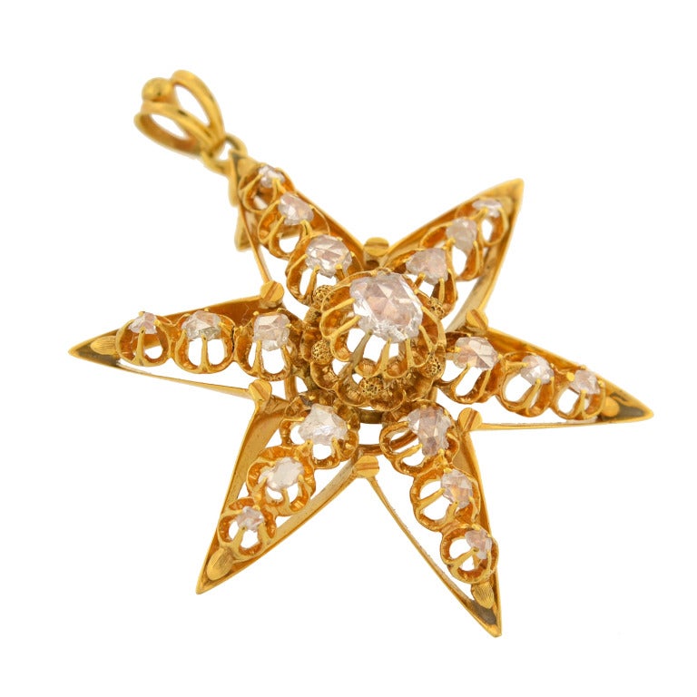 An absolutely gorgeous diamond star pendant from the Victorian (ca1880) era! This beautiful piece is particularly large in size and depicts a sparkling 6-point star. It is made of vibrant 18kt yellow gold and detailed with 18 old Rose Cut diamonds