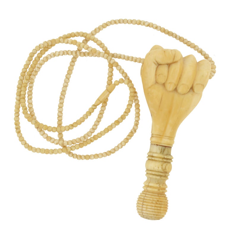 A beautiful and unusual hand carved ivory fist necklace from the Victorian (ca1880) era! This wonderful hand carved ivory necklace features a long strand of ivory beads with a clenched fist pendant at the center. The fist is particularly large in