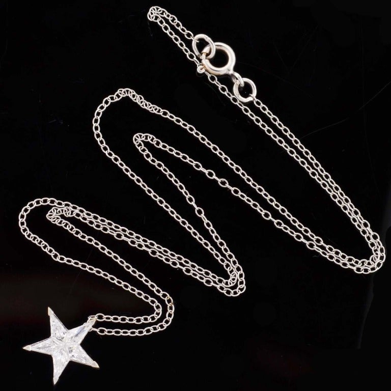A beautiful Estate diamond star necklace! Made of 18kt white gold, this lovely piece is comprised of a star shaped pendant that hangs from a fine 18kt white gold chain. The star pendant has 5 Kite Cut diamonds, which fit together perfectly to form