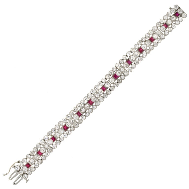 An absolutely stunning diamond and ruby encrusted bracelet from the Edwardian (c1915) era! This gorgeous piece is made of platinum and features 3 rows of sparkling diamonds and vibrant rubies. The bracelet holds a total of 122 old Mine Cut diamonds,