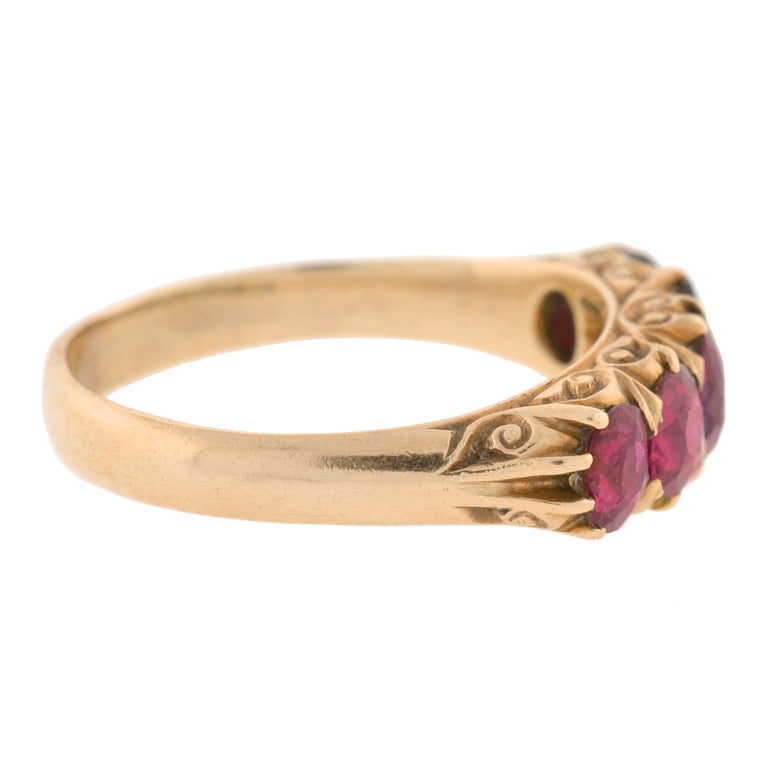 An absolutely gorgeous five stone ruby ring from the Victorian (c1880) era! This stunning piece is made of 14kt rose gold and features five gorgeous ruby stones that rest horizontally across the top of the ring. Each stone is a luscious raspberry