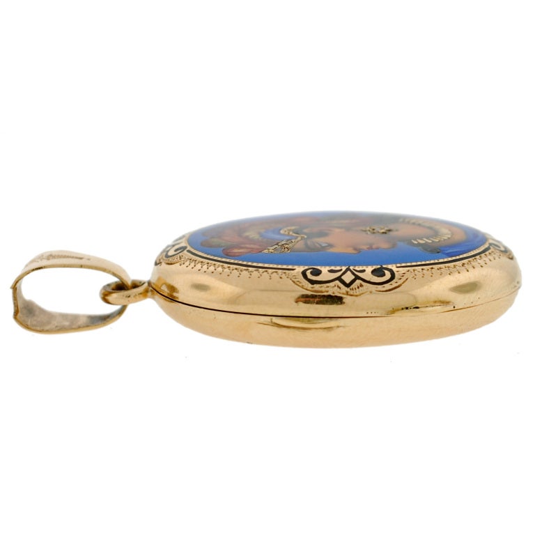An absolutely gorgeous gold and enamel locket from the Victorian (ca1880) era! This wonderful piece is made of 15kt yellow gold and has a vividly stunning portrait displayed on its face. The portrait is painted, with a layer of clear enamel placed