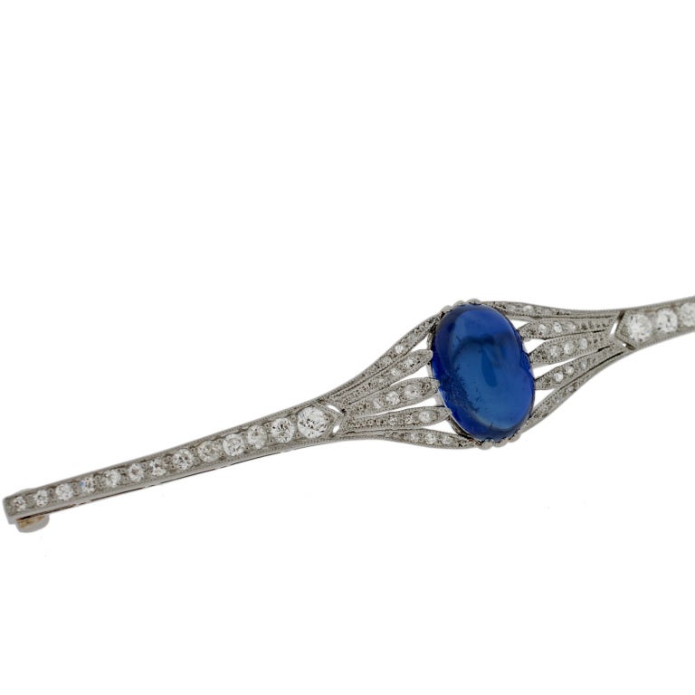 A stunning sapphire and diamond bar pin from the Edwardian (ca1910) period! This absolutely gorgeous handmade pin is made of platinum and encrusted with old Rose and Mine Cut diamonds. Bezel set within the center of the pin is a striking, oval