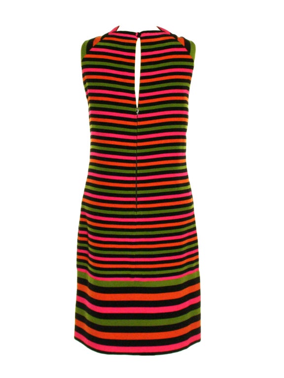 Wool, knee-length, sleeveless shift dress with horizontal stripes in hot pink, green, black and orange, with a high cowl neck, lined in black silk satin with back zipper closure and a fabric covered button. Matching black wool coat with fitted