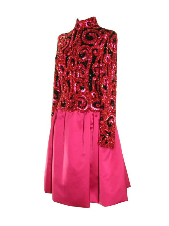 ou’ve won the golden ticket with this 1980's Bob Mackie fuchsia satin and beaded evening dress. You will be transported to a world of pure imagination upon examining the intricate beading on the long sleeves and banded collar bodice. Small red beads