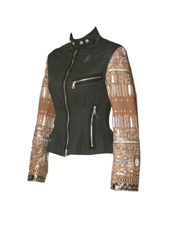 Turn heads on a fall day with this Dries Van Noten black embroidered jacket. This washed out aesthetic gives it that edge that you've been looking for. It's beige sleeves are heavily embellished and studded that is perfect for that rock n' roll