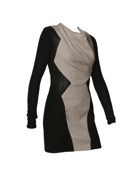 Helmut Lang is effortlessly emobided in this dress that contrast texture and color to strking effect.  This dress features a cowl neck out of gray and black wool with an elegant leather detail.