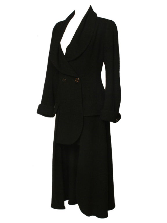 A classic essential like this Karl Lagerfeld black wool bouclé coat is the perfect way to update your wardrobe.  Featuring two buttons on the front and a unique short (in front) to long (in back) cut, this Karl Lagerfeld coat is a cool blend of