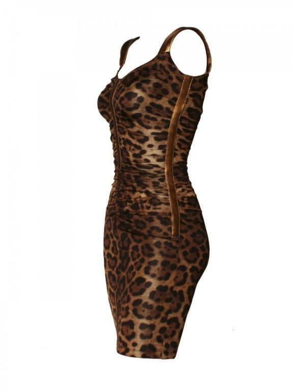 Master Dolce & Gabbana's combination of sexy and elegance with this Dolce & Gabbana gold leopard print dress.  With a striking bronze leather strap detail, this Dolce & Gabbana dress features a black and brown leopard print on stretch rayon, a back