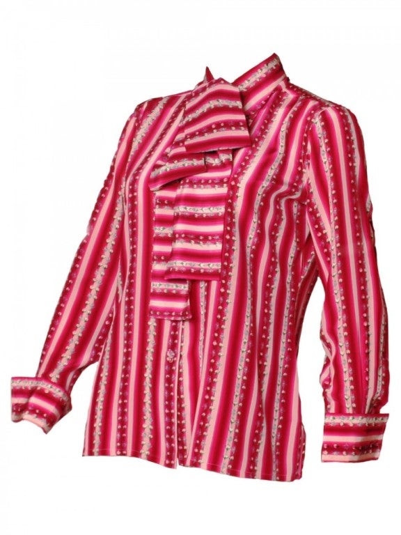 Give your closet the pop of color it deserves with our 1970's Lanvin striped silk secretary blouse.  Featuring horizontal stripes and rose details, this magenta button-up will have you wanting to go back in time.