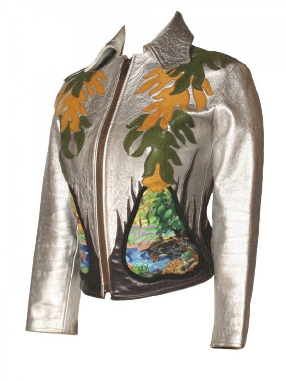 Rock out in this one-of-a-kind East West Musical Instruments Co. metallic leather jacket.  Giving the eye much to look at, this piece of art has flames stitched from the bottom and flame-like shapes also stitched from the top down.  Replacing where