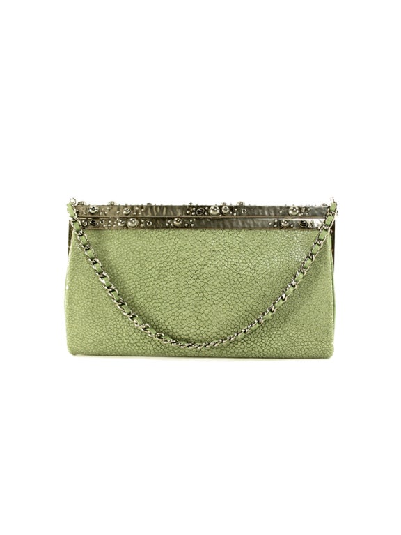 Prepare to upgrade your accessory repertoire with unstoppable sophistication with this stunning Coco Chanel limited edition stingray clutch. This magnificent accessory is beautifully crafted with magical green stingray, leather lining and pearl