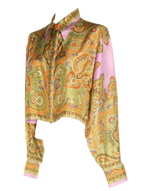 Join the ranks of Christy, Linda, & Naomi wearing this iconic 1990's Gianni Versace paisley blouse.  With a rich variety of hues:  purple, gold, green, red, yellow & blue and elaborate print, this blouse will keep you on trend.  This silk top is