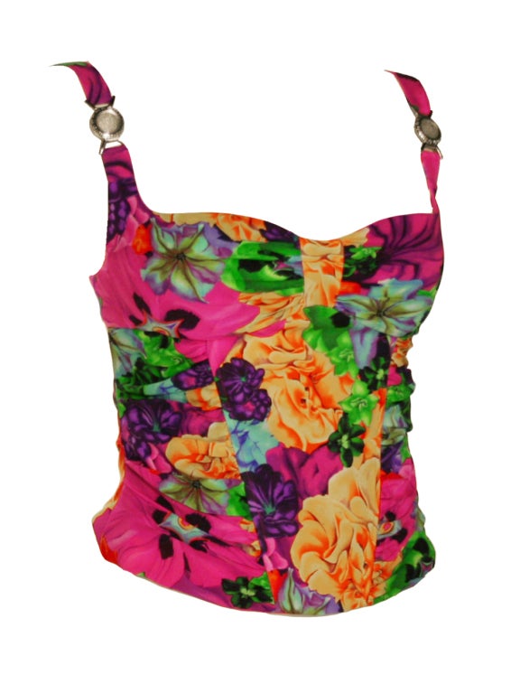Bring a dose of tropical influence to a day or evening look with Versace’s vibrant floral print bustier. Illuminated with eye catching hues of purple, yellow green and fuchsia, this piece is perfect boost of color for your repertoire. Multicolor
