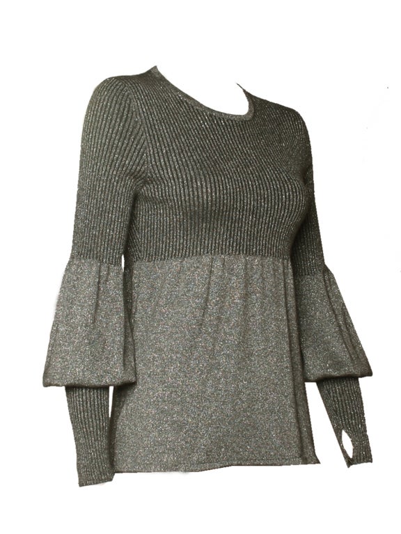 Whether dinning with the family or for a stroll at the city, Chanel silver lurex ribbed sweater will lend you the proper classic elegant touch that your outfits require. Chanel’s sweater feature unique asymmetrically-shaped sleeves that maintain