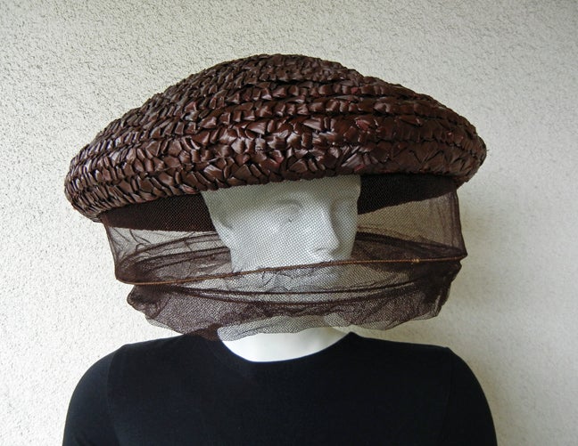 Rare Adrian Custom  crownless brown circular polished straw hat with chunky three (3) dimensional plaiting, in concept a la Bee Keeper complete with layered, wired protective netting.

Size: 17