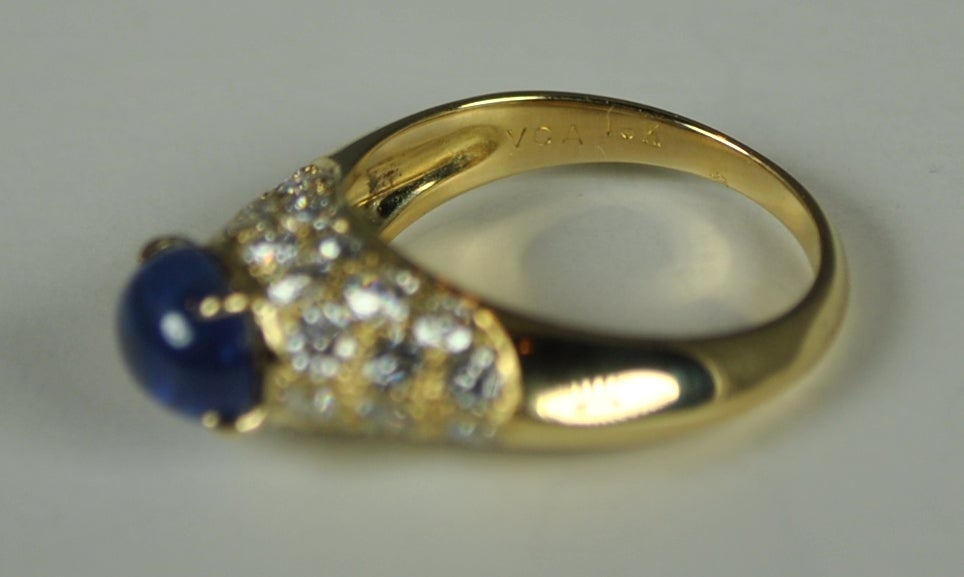 Fabulous VCA ring set with 32 round brilliant diamonds set in 18kt yellow gold.  This ring has a beautiful blue cabochon sapphire that is 2.04 carats. The sapphire is dome set above a variety of pave set diamonds with an approximate total weight of