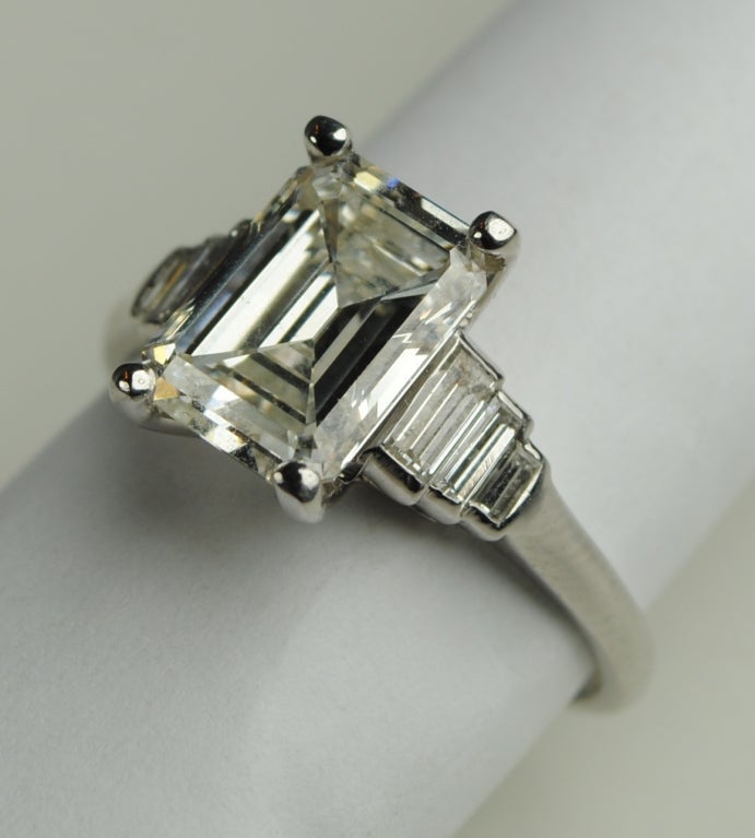 This fabulous Art Deco ring is simply elegant.  This large 2.67 carat diamond in the center measures 9.92X7.31X4.31mm.  This diamond has been pulled out and graded by GIA report #2155490388 as a I/SI1 although there are no imperfections seen even