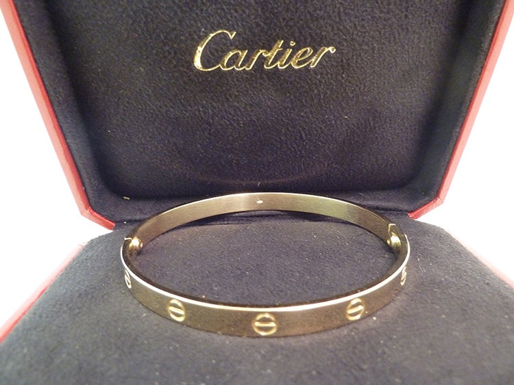 I’m so very proud to present this famous 18kt gold Cartier ‘Love’ Bangle, in the hard-to-find wide size '21' with the original Cartier Box! This beauty has an inside measurement of 7 ¾” x ¼”. On the inside it is heavily engraved with the Cartier