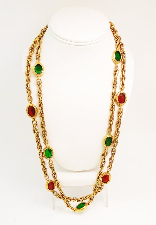 This fabulous Chanel necklace features 2-strands of the famous red and green Gripoix glass in a gold-tone setting. This piece has an inside strand measurement of 27” with a 3” extension. Each Gripoix glass medallion measures ¾” x 5/8” and the