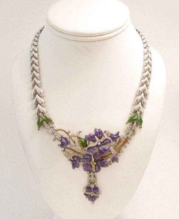 This is a very rare Trifari piece from the 1930’s that is all original, featuring purple, red, pink and green enameling with clear rhinestone accents in a rhodium setting.  The centerpiece measures 3” x 3” and the necklace is 17” x 3/8” with a