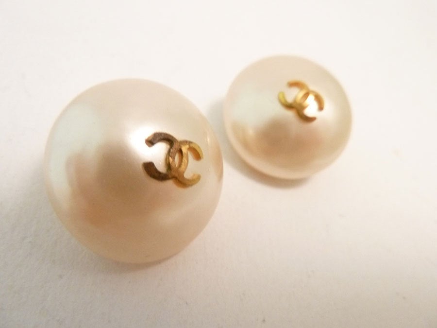 This is a perfect pair of vintage Chanel classic earrings.  These signed Chanel earrings feature faux pearls in a gold-tone setting with golden double CC in the center of each pearl.  In excellent condition, these clip earrings measure 7/8” in