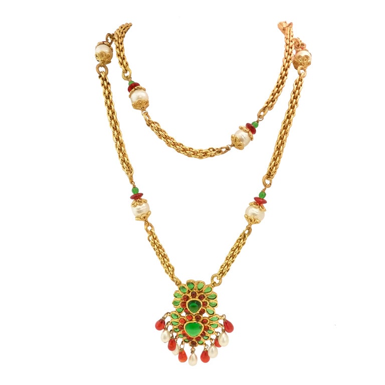 This is such a rare and stunning piece by Chanel featuring emerald and cranberry Gripoix glass with faux pearl accents in a gold-tone setting.  The pendant measures 3 ¼â?? x 2â?? and the necklace has an inside strand measurement of 29â?? x ½â??.  In