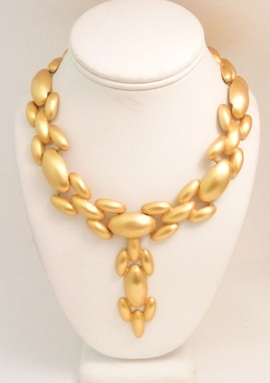 This vintage signed Givenchy necklace features a front drop in a gold-tone setting.  In excellent condition, the front drop measures 3 ½
