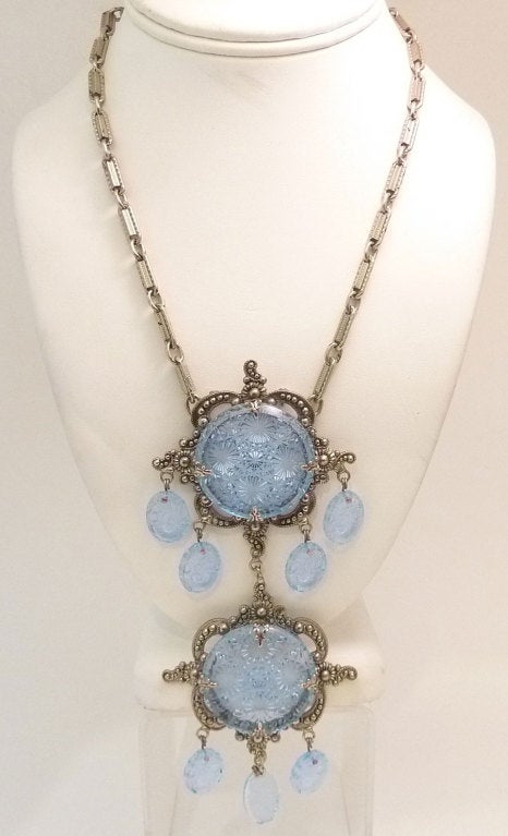 This vintage signed Schreiner pin/pendant necklace features carved floral designs in blue glass in a silver-tone setting.  The pin-pendant measures 6? x 2 ½? and the necklace is 19 ½? x 3/16?. As you can guess, the pin can be separated from the