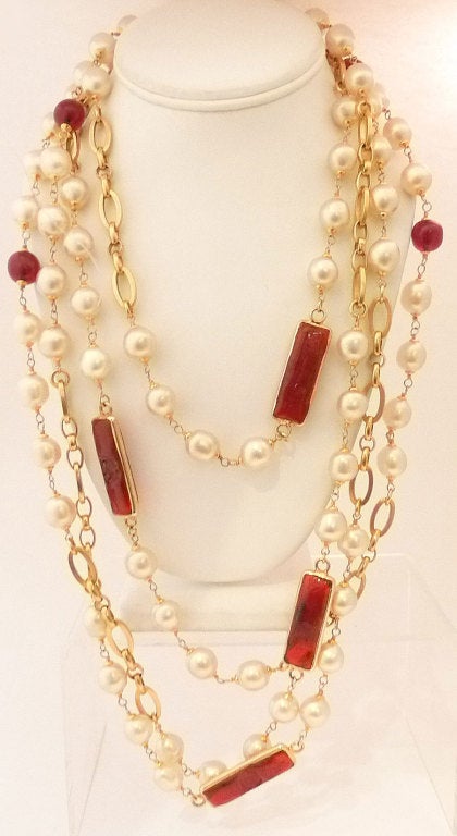 What is so special about this piece is the long rectangle Gripoix glass and the fact you can wear it three or four times around your neck giving you a full Chanel experience.  This vintage signed Chanel necklace features red Gripoix glass with faux