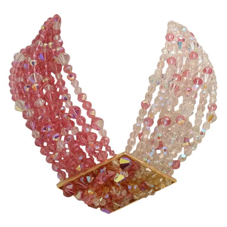 This vintage signed Jay Fineberg necklace features 10 strands of pink and clear glass beads in a gold-tone setting.  This necklace measures 16 ½? with a hook closure & the centerpiece is 3 ¼? x 2?.  In excellent condition, this multi-strand necklace