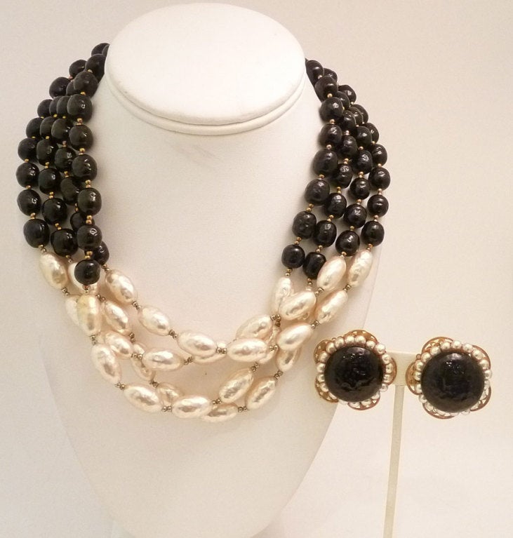 This vintage signed Miriam Haskell set features black glass beads and baroque shape faux glass pearls in a gold-tone setting.  The necklace measures 18? x apx 1 ½? with a push-in closure and the clip earrings are1 ¼? in diameter.  In excellent