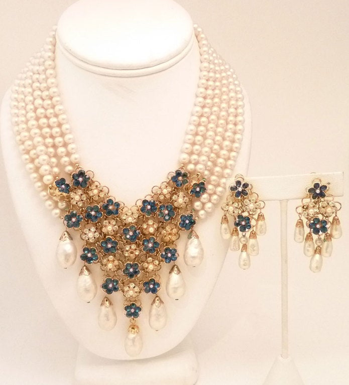 This vintage signed Vendome set features faux pearls with blue and clear rhinestone accents in a gold-tone setting.  In excellent condition, the necklace measures 16? with a front drop of 4? and a hook closure; the clip earrings are 2 1/8? x 1?.  In