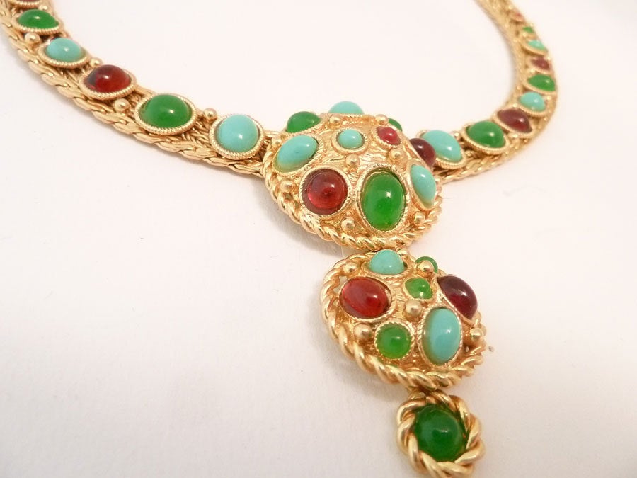 This vintage signed Christian Dior Germany necklace features turquoise, green and red stones in a gold-tone setting.  In excellent condition, this necklace measures 16 inches x ½ inch with a pressure closure.  The front drop is 2 ½ inches top to