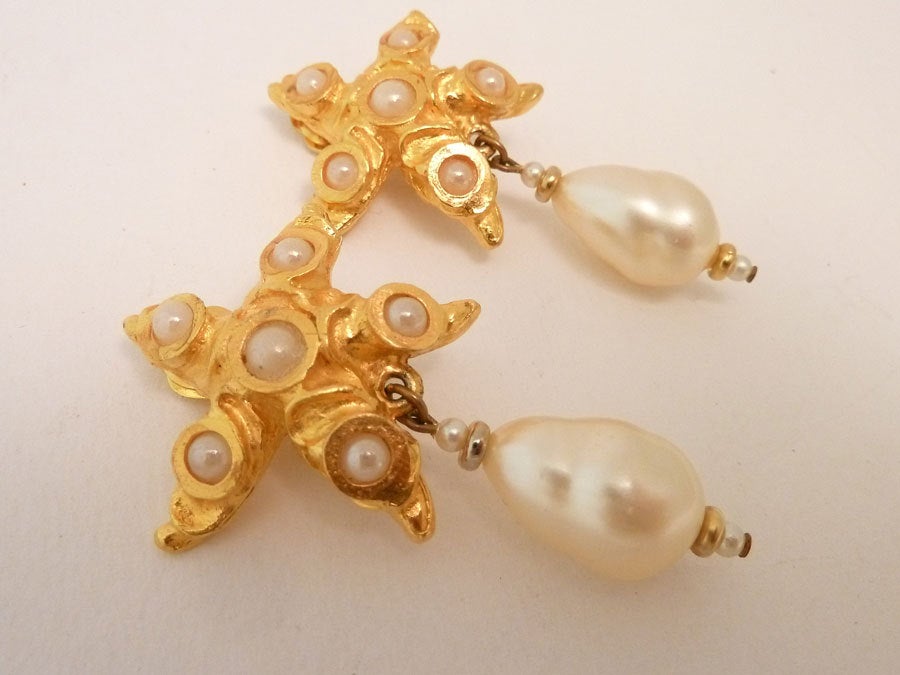 These vintage signed Oscar de la Renta earrings feature a starfish design with faux pearls in a gold-tone setting.  In excellent condition, these clip earrings measure 2 ½ inches  x 1 3/8 inches  and are signed Oscar de la Renta.